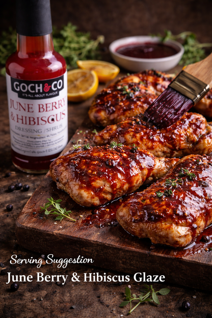 June Berry and Hibiscus Goch & Co dressing or shrub in a glass bottle with a colorful label, showcasing a vibrant, fruity beverage.