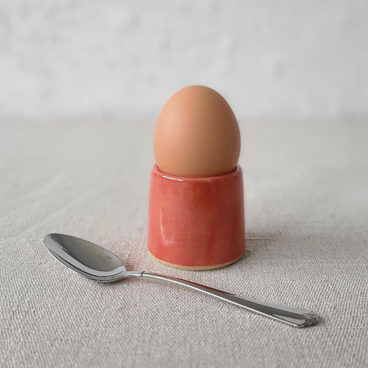 Cherry red classic egg cup by Katie L Thompson Designs, featuring a smooth ceramic finish and traditional shape.
