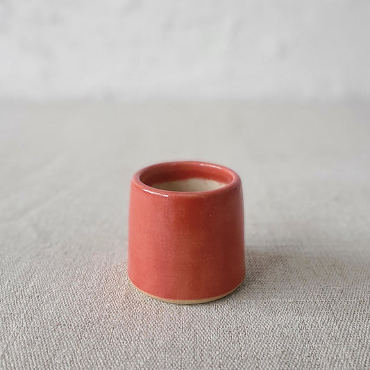 Cherry red classic egg cup by Katie L Thompson Designs, featuring a smooth, rounded ceramic design for serving eggs.