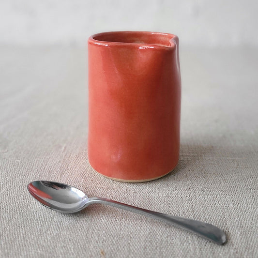 Cherry red small ceramic jug by Katie L Thompson Designs, with a classic shape and smooth finish.