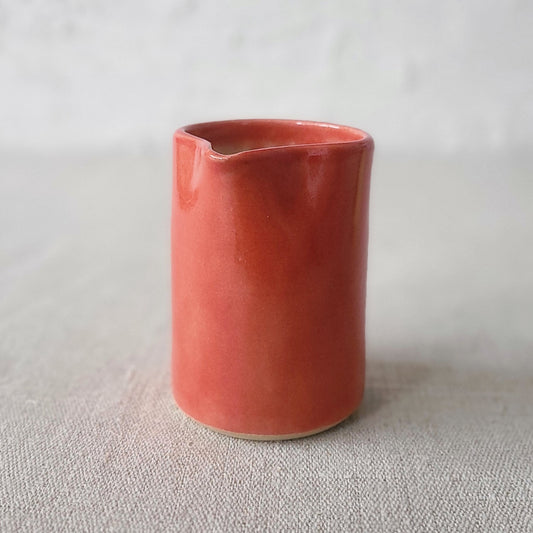 Cherry red small ceramic jug by Katie L Thompson Designs with a classic shape and smooth finish.