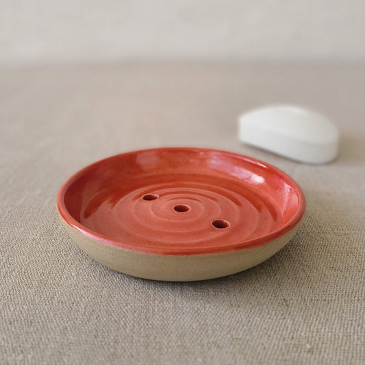 Cherry red ceramic soap dish from Katie L Thompson Designs with a classic rounded shape and glossy finish.