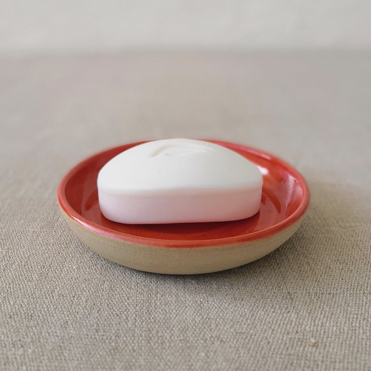 Cherry red classic soap dish by Katie L Thompson Designs, featuring a smooth, curved ceramic design for bathroom use.