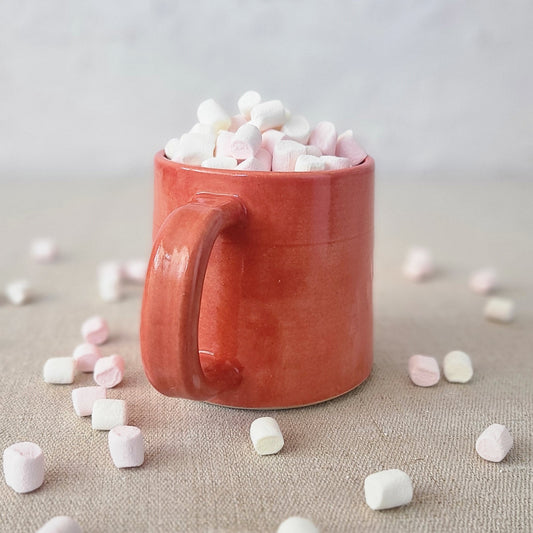 Cherry red Katie L Thompson Designs standard mug with scattered marshmallows pattern, perfect for hot beverages.