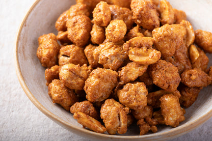 Whole Food Earth chilli honey caramelized peanuts in a bowl, showcasing crunchy coated nuts with a spicy sweet glaze.