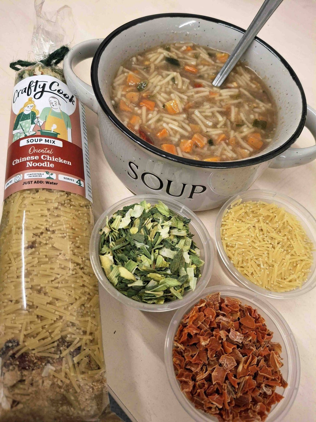 Crafty Cook Easy Meals Starter Plan image showing a bowl of Chinese chicken soup with fresh ingredients and garnishes.