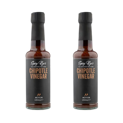 Two bottles of Spicy Ryes Chipotle Vinegar with dark glass bottles and labels featuring smoky chipotle peppers.