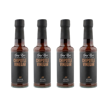 Four bottles of Spicy Ryes chipotle vinegar with dark glass bottles and red labels, used for flavorful cooking and dressings.