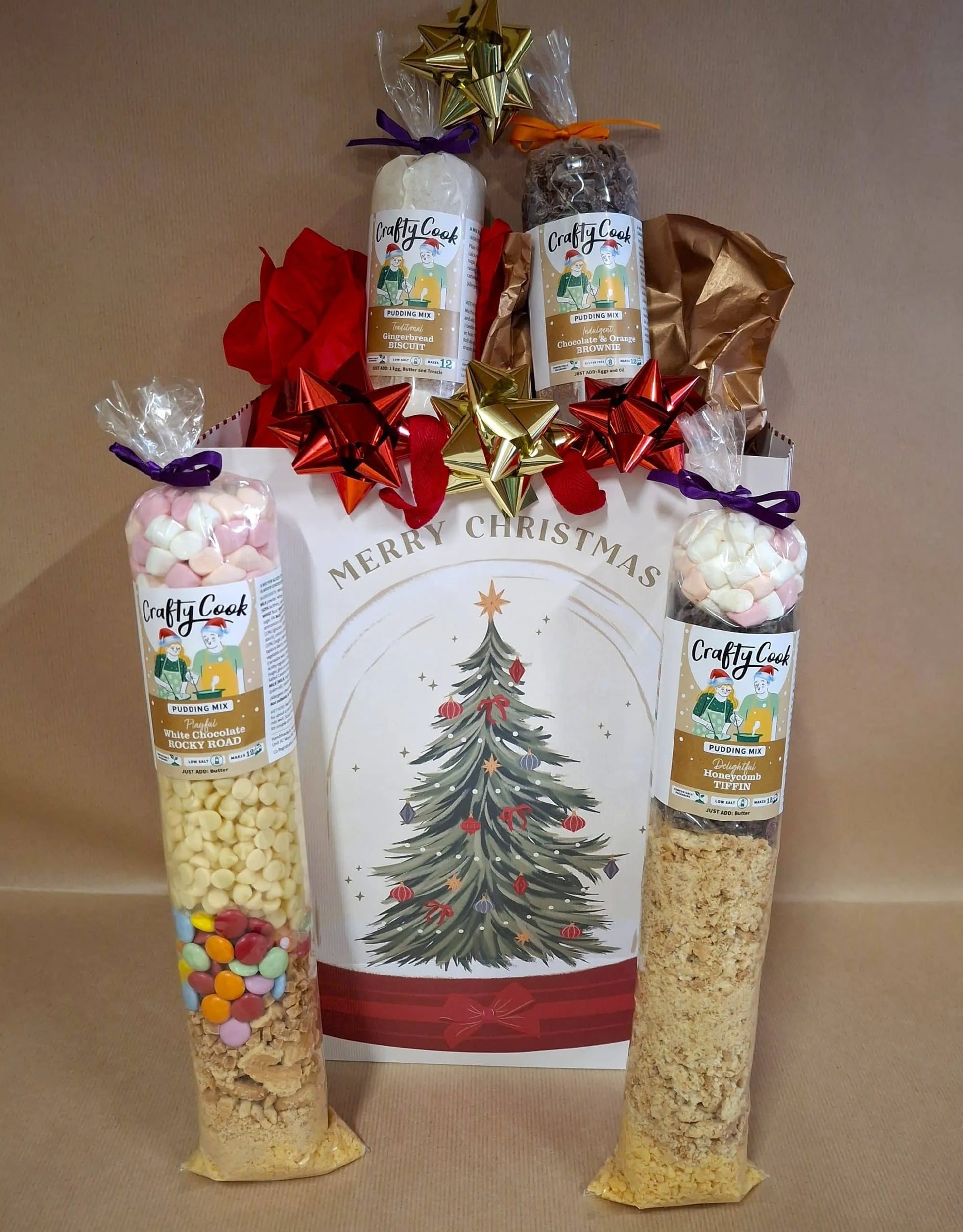 Crafty Cook Christmas hamper with assorted pudding bundle, featuring festive holiday desserts and treats in a decorative gift box.