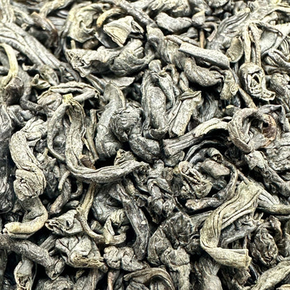Dried green tea Chunmee leaves from Porter Hill Tea Company, showcasing their light, twisted appearance and fresh green color.