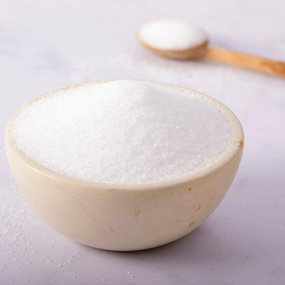 Food grade citric acid from Whole Food Earth, in a clear container, used as a natural mineral salt for culinary and preservative purposes.