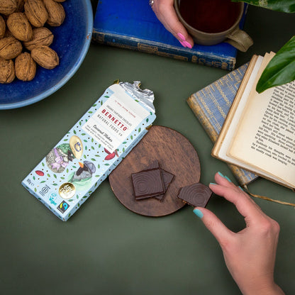 Bennetto Natural Foods UK chocolate coconut flakes in a bowl, showing toasted coconut flakes with chocolate coating.