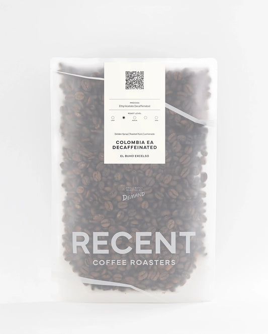 Decaf Colombia El Buho Excelso medium roast coffee beans from Recent Beans, showcasing fresh, roasted coffee in a bag.