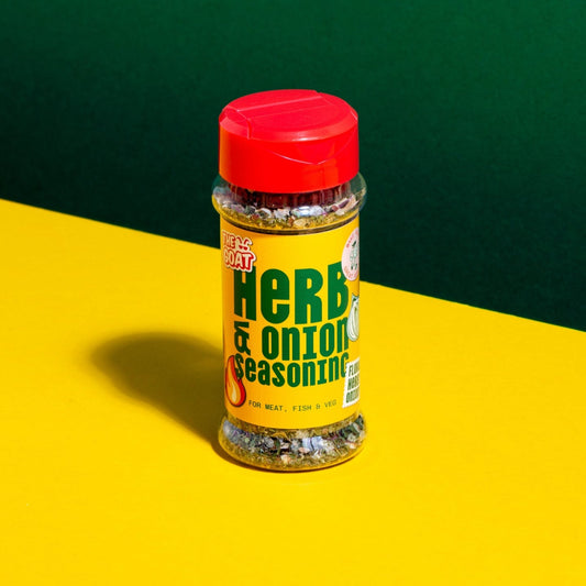 Herb and Onion seasoning blend in a 28g shaker bottle from The GOAT Seasoning Blends, with herbs and onion visible inside.