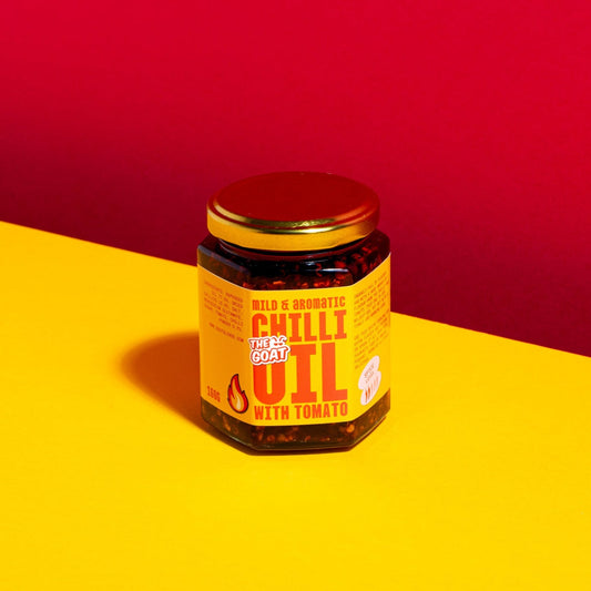 Asian mild and aromatic chili oil in a 160g jar by The GOAT Seasoning Blends, showing a clear jar with vibrant chili oil inside.
