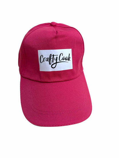 Crafty Cook cerise pink all-purpose cap with adjustable strap and breathable fabric, ideal for cooking or outdoor activities.