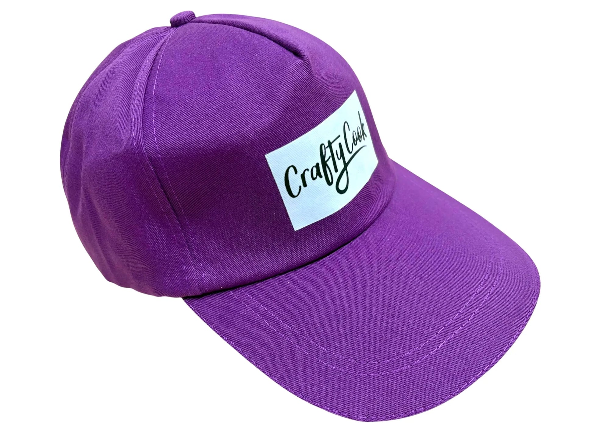 Purple Crafty Cook cap with adjustable strap, made of soft fabric, featuring the Crafty Cook logo, designed for all-day comfort.