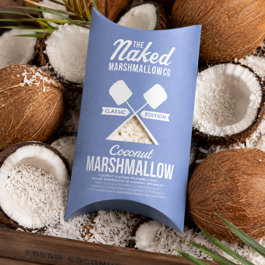 Close-up of a coconut gourmet marshmallow from THE MARSHMALLOW FACTORY, showcasing its fluffy texture and coconut coating.