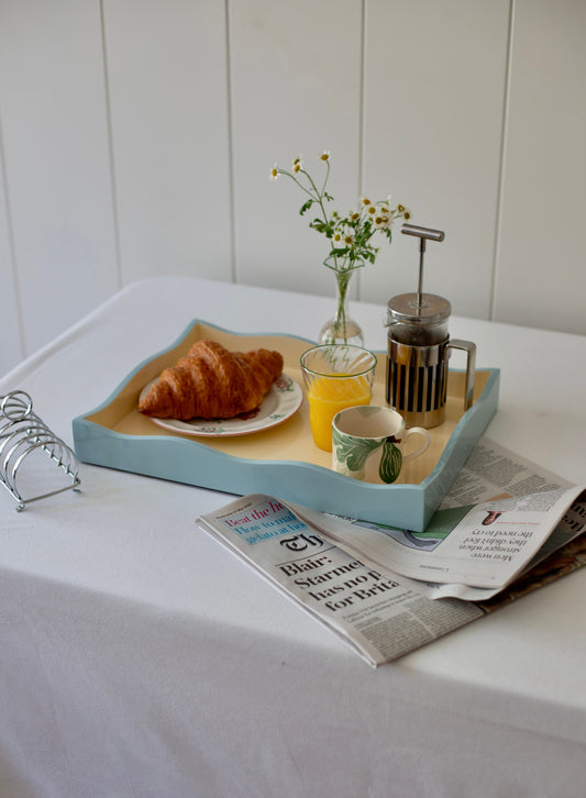 Allegra Wiggle Tray by domenicamarland in blue and cream with a wavy, textured design on a neutral background.