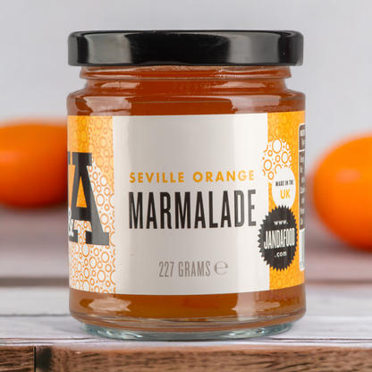 Janda Seville Orange Marmalade jar with a spread of marmalade on toast, showcasing the bright orange color and glossy texture.