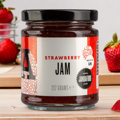 Jar of Janda strawberry jam with fresh strawberries and spread on bread, showcasing the fruit-filled spread.