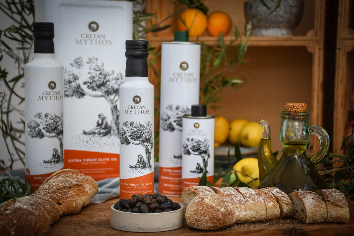 Cretan Mythos Extra Virgin Olive Oil bottle from The Greek Deli Club, showcasing a golden olive oil in a clear glass bottle.