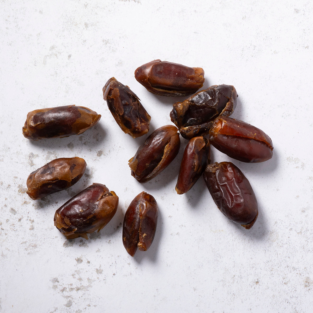 Pitted free-flow dried dates from Whole Food Earth, showing glossy, dark brown dates in a clear container.
