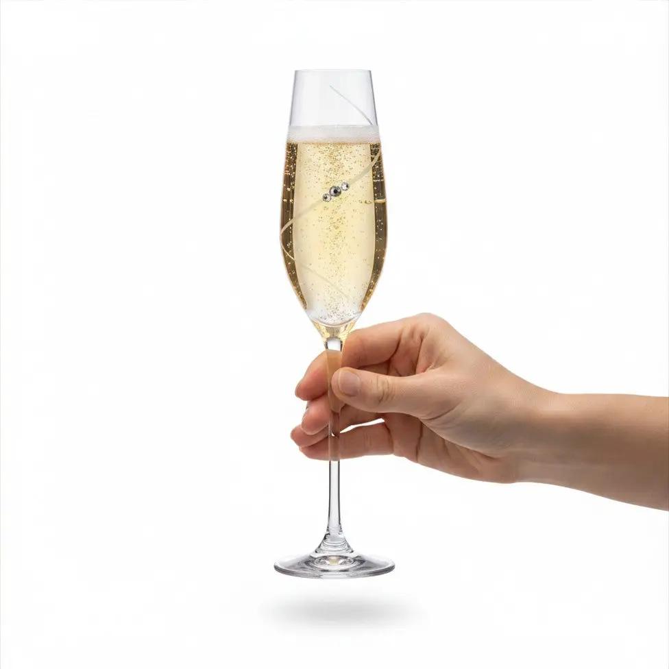 Six clear glass champagne flutes with diamanté embellishments, held in hand, showcasing elegant design by Glassware UK.