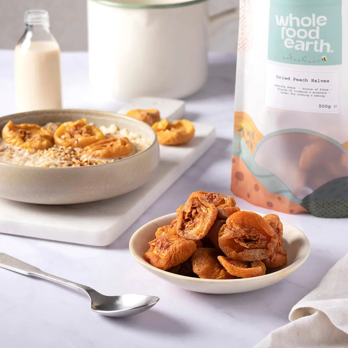Dried peach halves from Whole Food Earth, showcasing vibrant orange dried fruit slices on a rustic wooden surface.