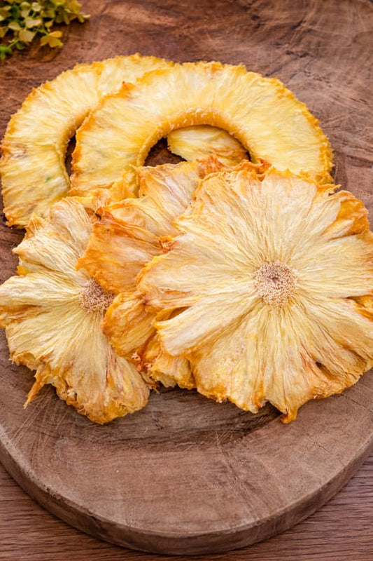 Dried pineapple slices from JoJo’s Kitchen, showing golden, chewy fruit pieces with textured surface and natural sweetness.