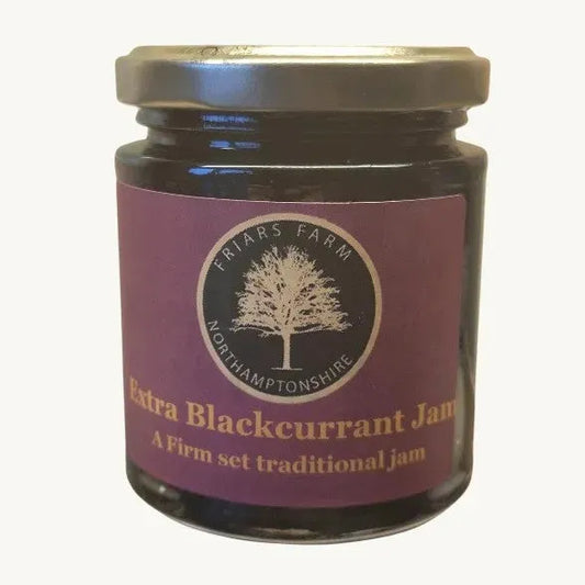 Jar of Friars Farm Extra Blackcurrant Jam 200g with dark purple jam visible inside, featuring a label and a wooden spoon.