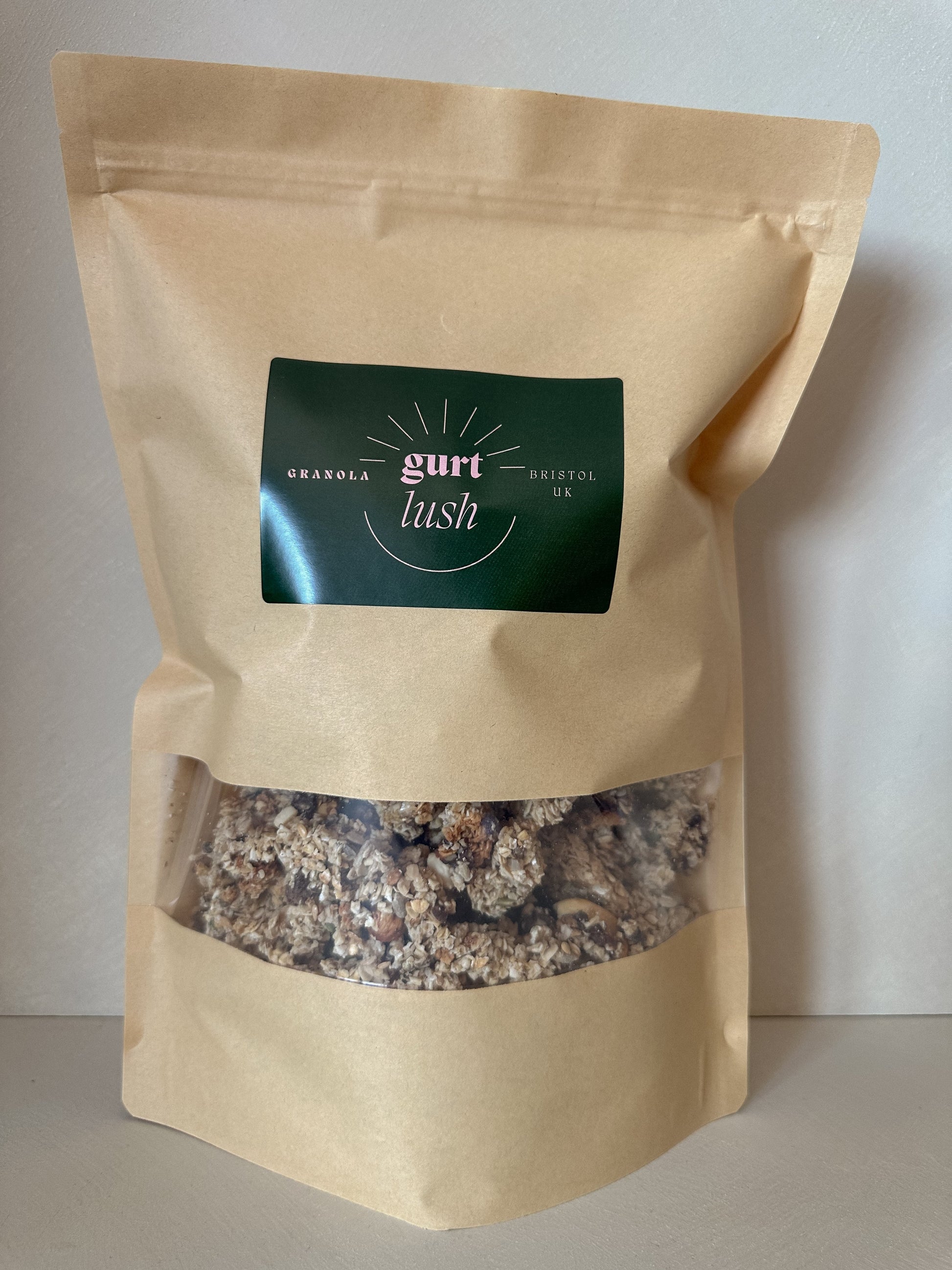 Dark chocolate, nut, and seed granola from Gurt Lush Food Co displayed in a bowl with visible chocolate chunks, nuts, and seeds.