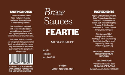 Braw Sauces Feartie Hot Sauce bottle with fiery red chili peppers and vibrant label on a wooden surface