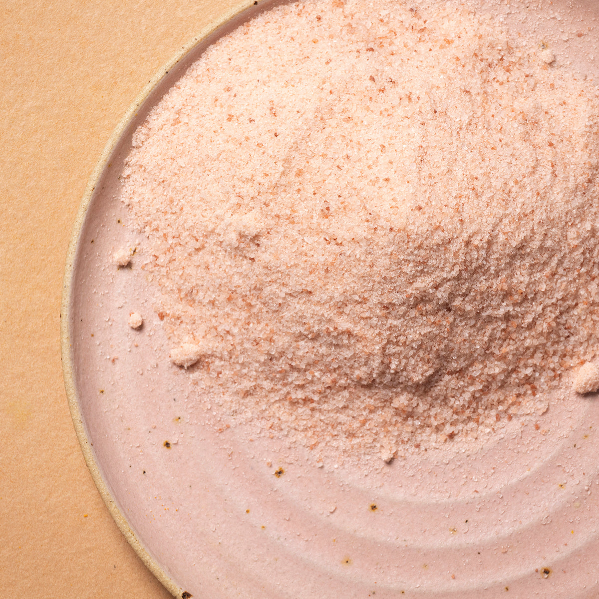 Fine Himalayan salt crystals from Whole Food Earth, showcasing the pink mineral salt used for cooking and seasoning.