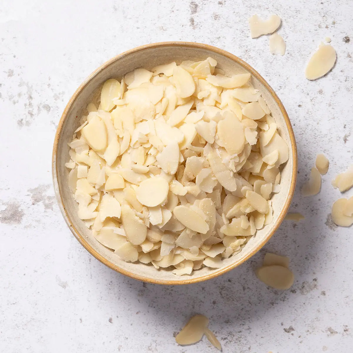 Fresh flaked almonds from Whole Food Earth, a natural nut and seed product, shown in a close-up image.