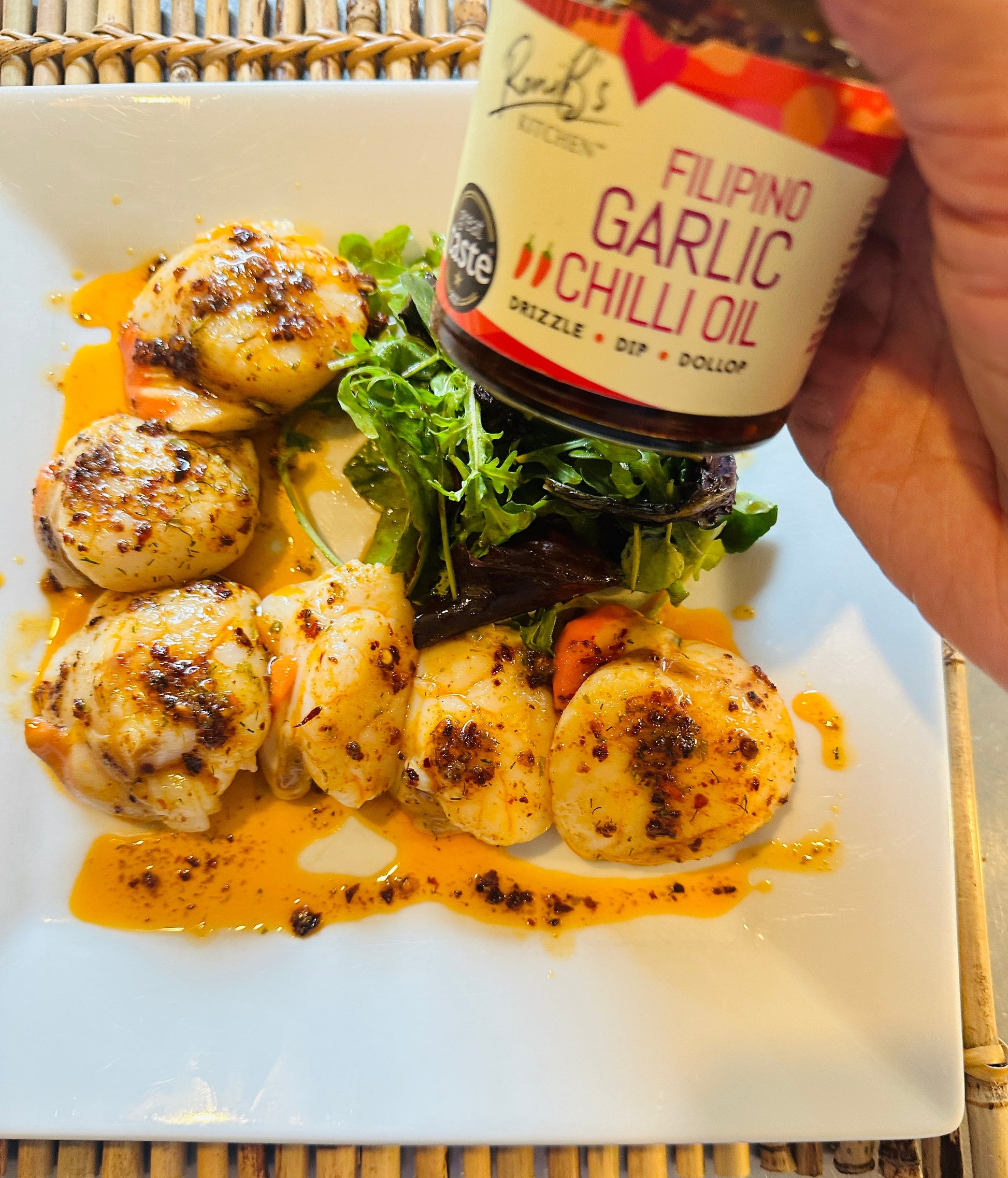 Filipino style garlic chili hot sauce by RoniBs Kitchen with scallops, showcasing a spicy, flavorful sauce in a glass jar.