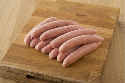 Gluten-free pork chipolata sausages from Primrose Herd, cooked and ready to serve on a plate