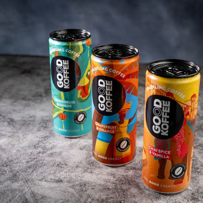 Three cans of GOOD KOFFEE sparkling coffee in a discovery taster box, showcasing colorful labels and refreshing beverage design.