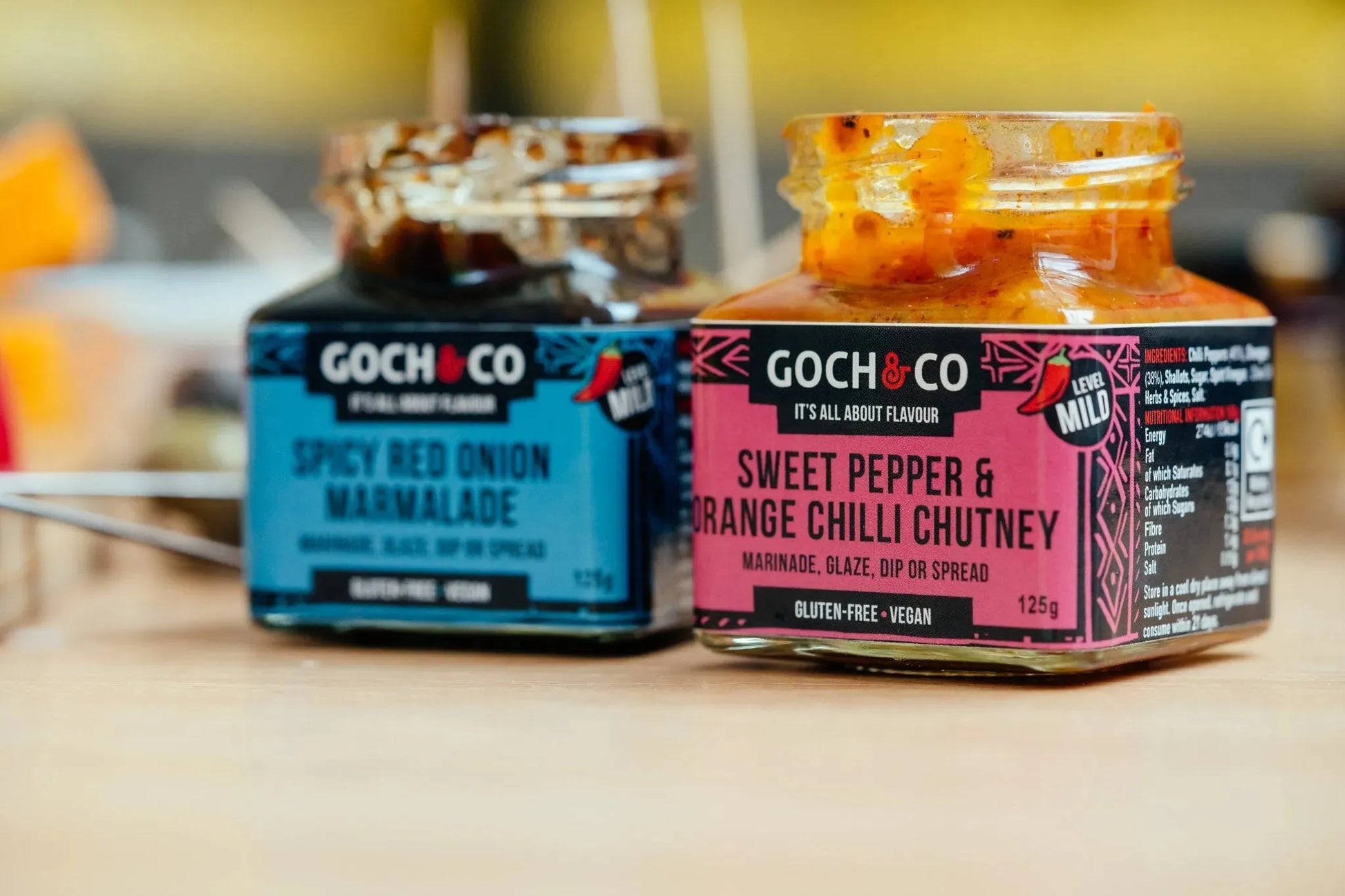 Sweet pepper and orange chili chutney jar from Goch & Co, showcasing its vibrant color and chunky texture in a clear glass jar.