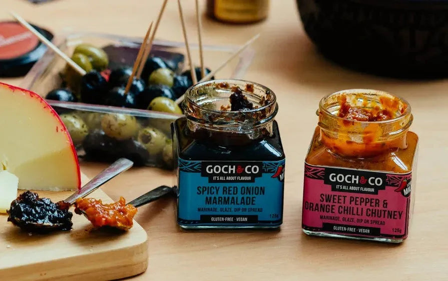 Sweet pepper and orange chili chutney in a glass jar, showcasing its vibrant orange and red colors with visible chunks of peppers and chilies.