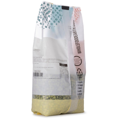Green Whole Food Earth split peas in a 1kg bag, showing fresh green beans and pulses for cooking or soups.