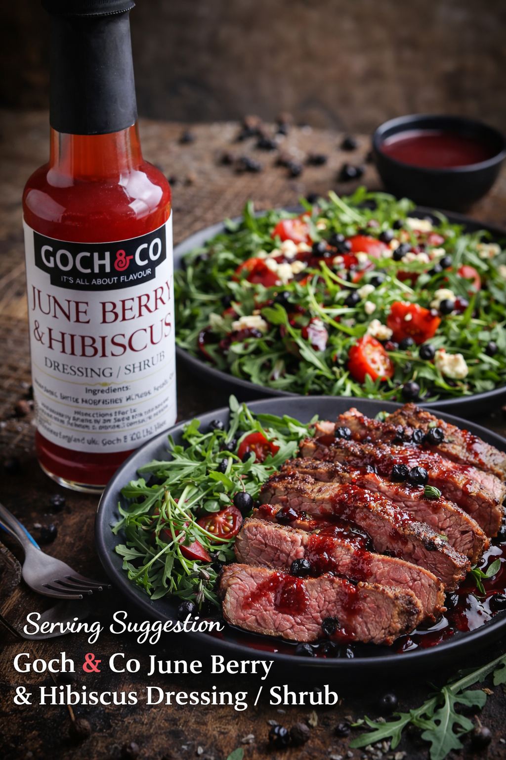 Goch & Co June Berry and Hibiscus dressing drizzled over grilled steak and fresh salad for vibrant flavor and presentation.