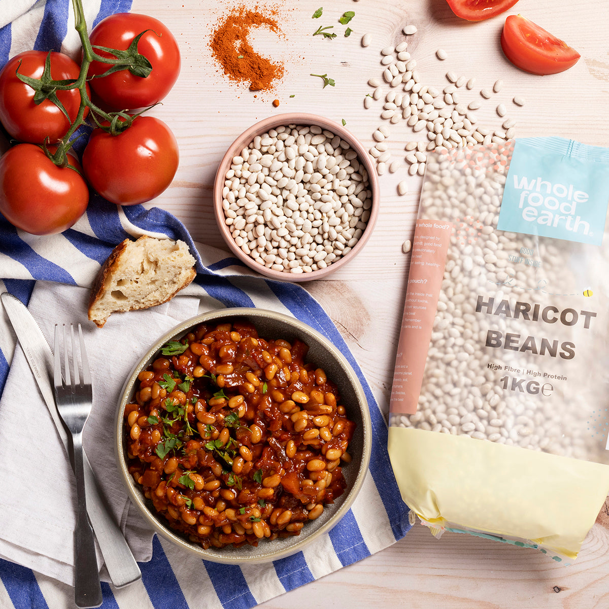 Whole Food Earth haricot beans in a bowl with fresh vegetables on a rustic table, showcasing healthy beans and pulses.