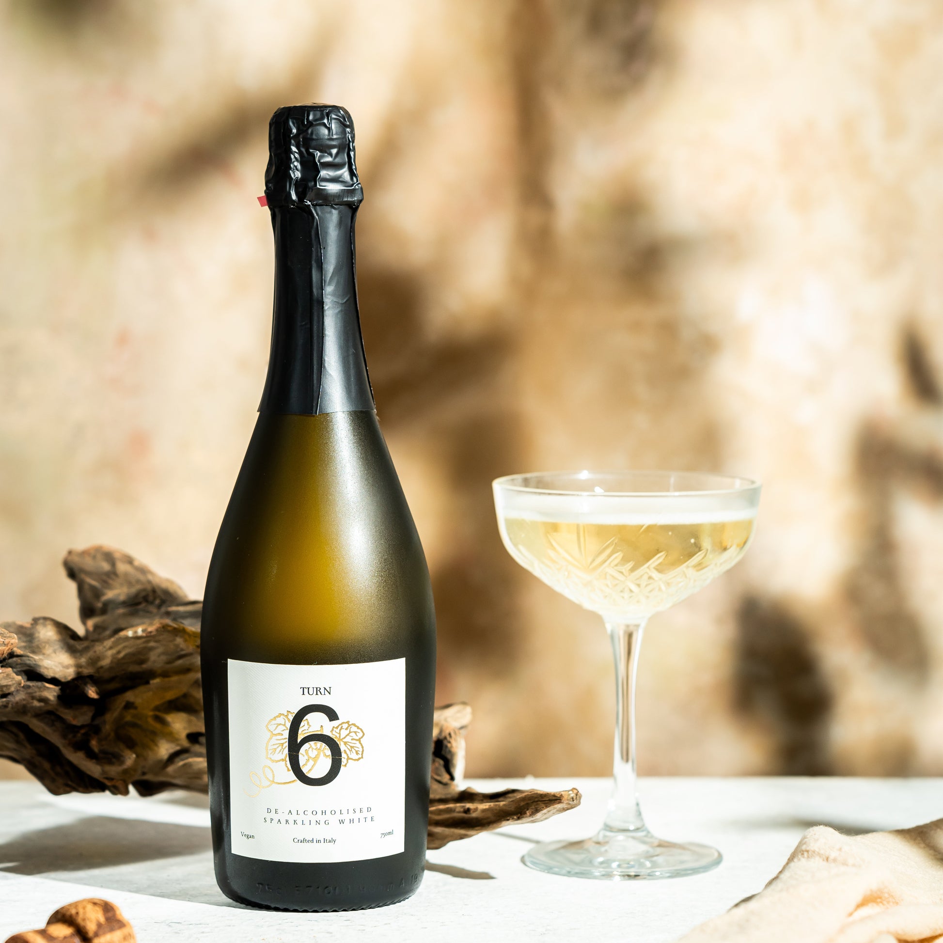 Glass of Turn 6 alcohol-free sparkling white wine in a flute, showcasing its clear, bubbly appearance and elegant presentation.