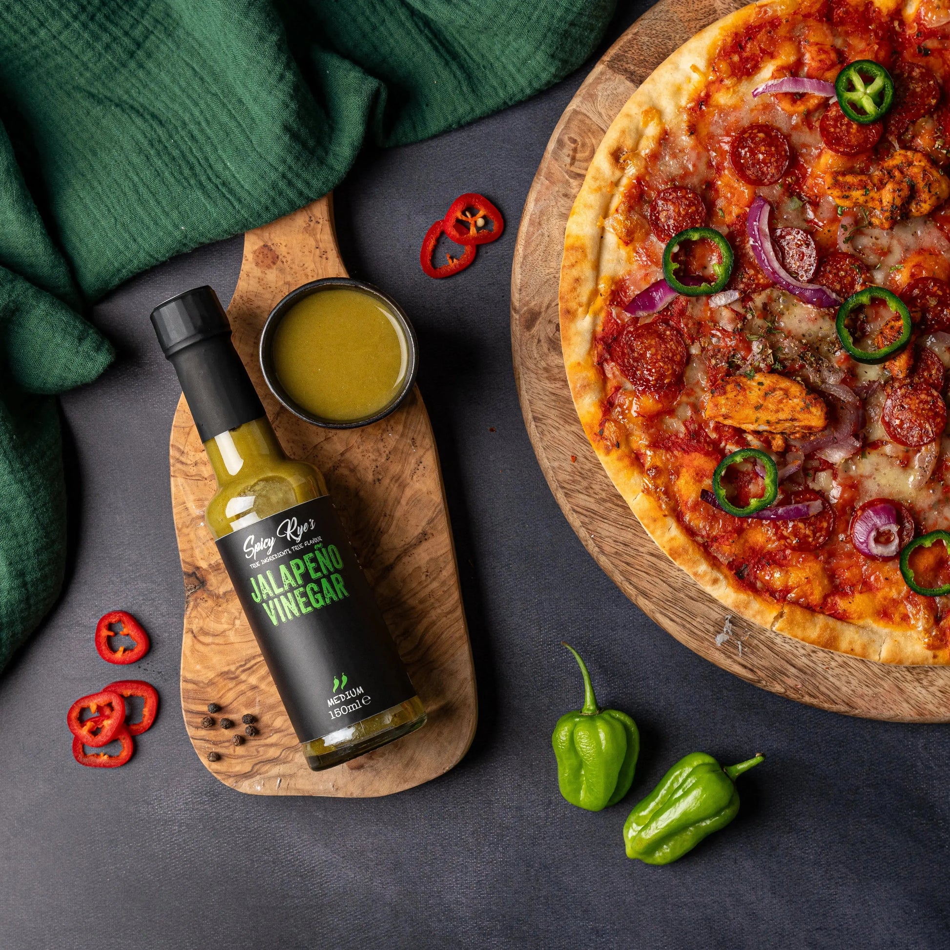 Spicy Ryes Jalapeño Vinegar in a glass bottle, showcasing vibrant green jalapeño peppers and clear vinegar inside.