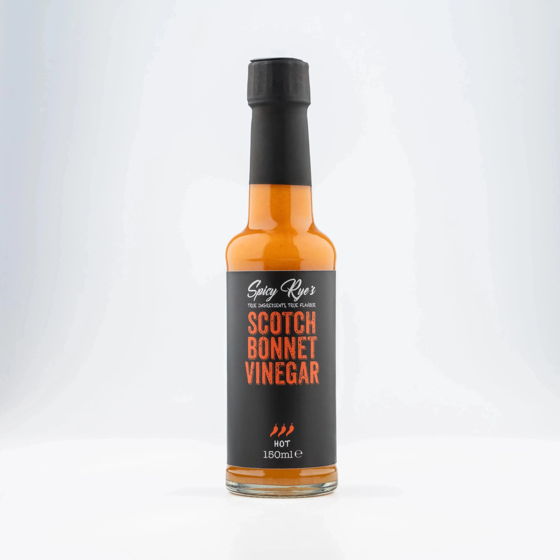 Spicy Ryes Scotch Bonnet vinegar bottle with red label and chili pepper illustration, close-up shot on a white background.