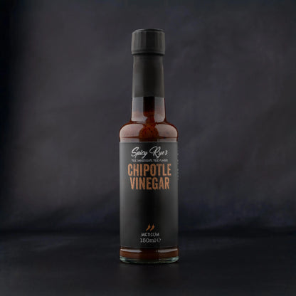 Spicy Ryes Chipotle Vinegar bottle with dark liquid inside, featuring a label with chipotle peppers and branding.