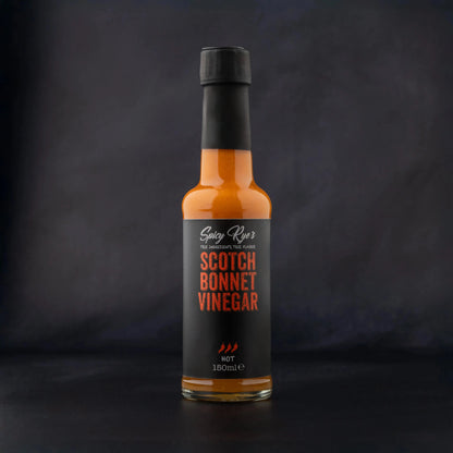 Spicy Ryes Scotch Bonnet Vinegar bottle with label, showcasing bright red chili peppers and bold branding on a white background.