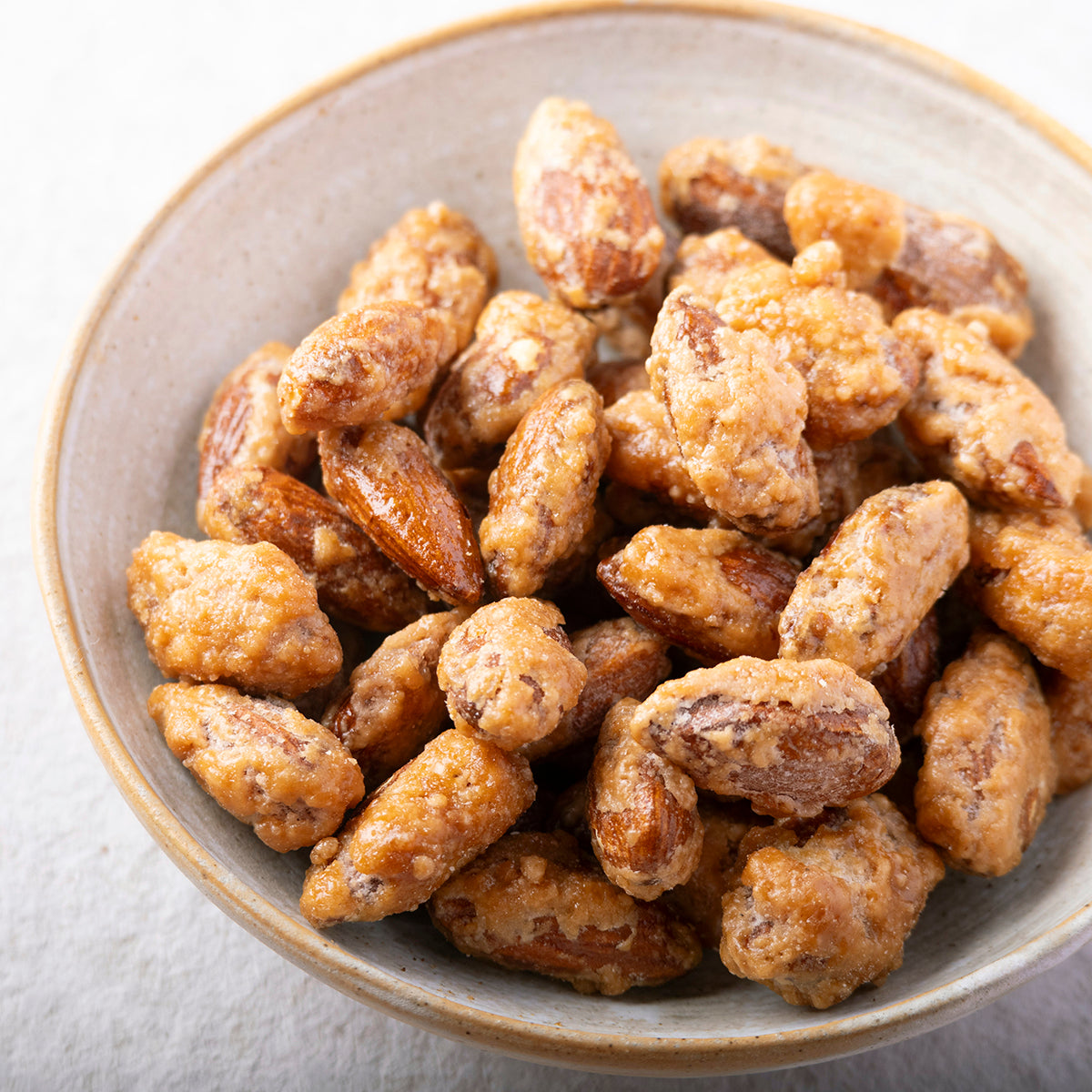 Honey caramelized almonds from Whole Food Earth, showing golden-brown nuts coated in sweet honey glaze.