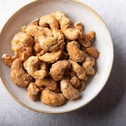 Honey caramelized cashews from Whole Food Earth, coated with sweet honey glaze, in a close-up shot highlighting their crunchy texture.